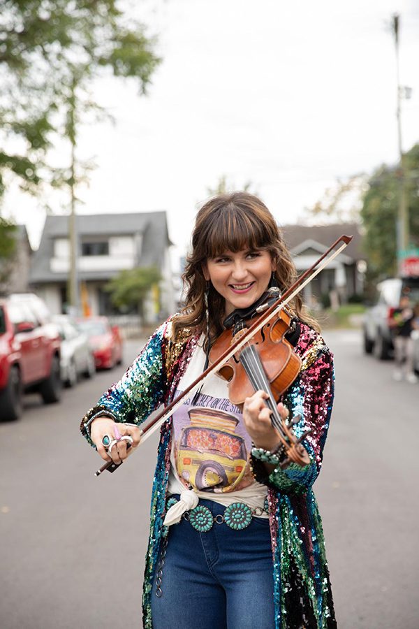 Jenee Fleenor playing her fiddle in the middle of a street